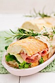 Baguette sandwiches with lettuce, sliced cheese and salami