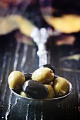 Black and green olives on a vintage spoon