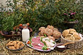 An autumnal buffet with rolls, sausages and vegetables in a garden