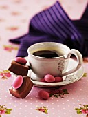 Marzipan sweets and chocolate-coated almonds with a cup of coffee