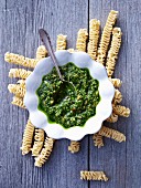 A bowl of pesto on raw pasta