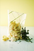 Gnocchi in a plastic bag and fresh thyme