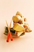 Fresh ginger on a dish with chopsticks