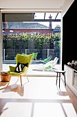 Sunny interior with floor-to-ceiling sliding doors leading to sun terrace