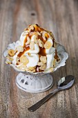 Frozen yogurt with caramel sauce and slivered almonds