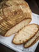 A freshly baked homemade loaf of wheat sourdough bread, sliced