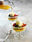 Vanilla ice cream with fresh berries and orange sauce
