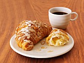 Croissants with slivered almonds and coffee