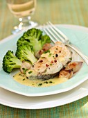 Hake with a butter sauce and broccoli