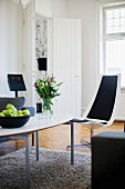 Modern, classic-style coffee table on flokati rug and elegant, white shell chair with black seat and backrest cushions