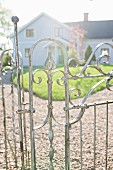 Country house seen through wrought iron gate