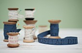 Printed ribbons wound on vintage wooden reels