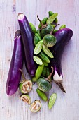 An arrangement of aubergines and cucumbers