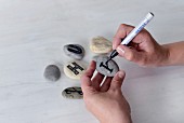 Writing letters on pebbles