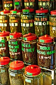 Various types of tea and coffee in jars at a market in Saigon (Vietnam)