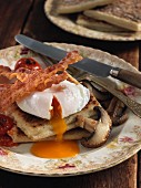Potato farls (fried potato bread) with egg, bacon and mushrooms (Irish breakfast)