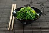 A bowl of seaweed salad with chopsticks (Japan)
