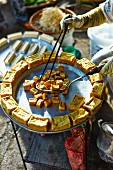 A woman selling fried tofu at a market in Haiphong, Vietnam