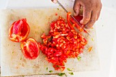 Ceviche being made: tomatoes being chopped