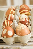 Dyed Easter eggs in egg carton