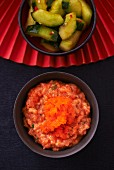 Salmon tartar with orange caviar and a spicy cucumber salad