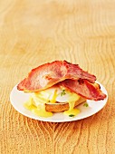 Eggs Benedict (toast topped with a poached egg, bacon and Hollandaise sauce)