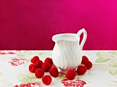Raspberries and a jug of cream