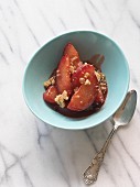 Plum compote with almond muesli in a light blue bowl