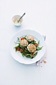 Fish cakes on a bed of tomato and rocket salad