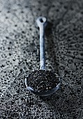 Black sesame seeds on a spoon