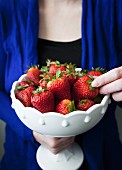 Fresh strawberries in a porcelain bowl