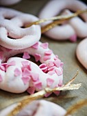 Meringue rings scattered with sugar hearts as Christmas tree decorations