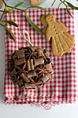 Spice bauble and almond biscuit on gingham cloth