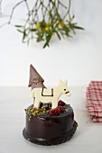 Chocolate cake decorated with a donkey and a Christmas tree
