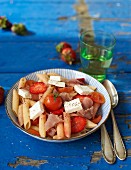 Penne pasta with strawberries, ham and feta cheese
