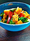 Pumpkin salad with pepper, spinach and black sesame seeds