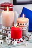 Pillar candles decorated with alphabet washi tape and alphabet dice