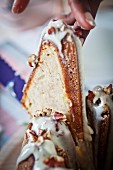 Bundt cake with nuts and icing sugar (close-up)