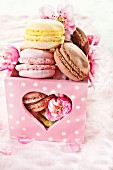 Macaroons in a heart-shaped box with apple blossoms