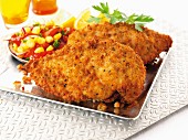Breaded chicken breast with a tomato and sweetcorn salad
