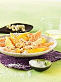 Melon and mango salad with cashew nuts and grated coconut