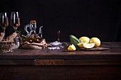 Lemons, olive oil and white wine on a wooden table