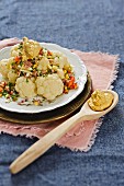 Cauliflower salad with ham, cheese and pepper served with a mustard dressing
