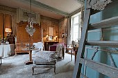 A sales exhibition of antique furniture in the parlour of an old French country house