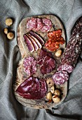 A charcuterie board featuring Grisons air-dried beef and salami