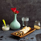 Sweet tortillas with pears and pine nuts on a wooden dish
