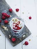 Vanilla ice cream with raspberries and roasted, flaked almonds