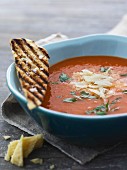 Tomato soup with parsley, grated cheese and croutons