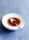 Caramel sauce on a plate with a spoon
