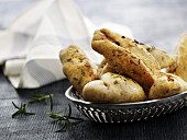 Ciabatta rolls with rosemary in a metal basket